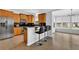 Open kitchen featuring light wood cabinets, stainless appliances, black countertops, and eat-in bar at 2207 Concordia Se Way # 12, Mableton, GA 30126