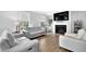 Bright living room with fireplace, white sofas, and wood floors at 2207 Concordia Se Way # 12, Mableton, GA 30126
