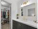 Elegant bathroom featuring a modern vanity with brass fixtures and a doorway to a walk-in closet at 2808 Vinings Central Se Dr # 158, Atlanta, GA 30339