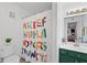 Colorful bathroom with a sink and vanity and a shower with a vibrant alphabet curtain at 2808 Vinings Central Se Dr # 158, Atlanta, GA 30339