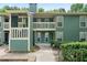 View of a two-story building featuring green siding, white trim, and multiple balconies at 2808 Vinings Central Se Dr # 158, Atlanta, GA 30339