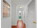 Hallway featuring wood floors, white walls, closets, and a view to a green-themed bathroom at 2808 Vinings Central Se Dr # 158, Atlanta, GA 30339