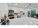 Bright kitchen with white cabinets, quartz countertops, stainless appliances and breakfast bar at 2808 Vinings Central Se Dr # 158, Atlanta, GA 30339