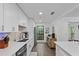 Updated kitchen featuring white cabinets, quartz countertops, stainless appliances, and wood floors at 2808 Vinings Central Se Dr # 158, Atlanta, GA 30339