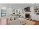 Inviting living room with a large sectional sofa, fireplace, TV, and built-in bookshelves at 2808 Vinings Central Se Dr # 158, Atlanta, GA 30339