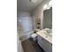 Clean bathroom includes tub with shower, white vanity, and coordinated decor at 4263 Notting Hill Sw Dr, Atlanta, GA 30331