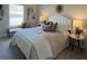 Cozy bedroom featuring a comfortable bed with elegant bedding, a side table, and warm lighting at 4263 Notting Hill Sw Dr, Atlanta, GA 30331