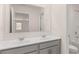 Bright bathroom featuring double sinks with white countertops and gray cabinetry with a large mirror at 1949 Van Allen Ct, Dacula, GA 30019