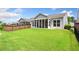 Spacious backyard with lush lawn, fence, and screened-in porch at 215 Windsor Park Dr, Woodstock, GA 30188