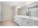 Bathroom with a double vanity sink, shower, and a large mirror above the sink at 215 Windsor Park Dr, Woodstock, GA 30188
