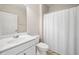 Bathroom with single vanity, toilet and shower with white curtain at 215 Windsor Park Dr, Woodstock, GA 30188