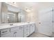 Well-lit bathroom with double sinks and large mirror at 215 Windsor Park Dr, Woodstock, GA 30188