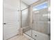Modern bathroom features a tiled walk-in shower with seamless glass door and a built-in seat at 215 Windsor Park Dr, Woodstock, GA 30188