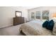Bedroom with queen bed, carpet, and large window at 215 Windsor Park Dr, Woodstock, GA 30188