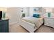 Charming bedroom is furnished with a queen bed, side tables, lamps and ocean themed artwork at 215 Windsor Park Dr, Woodstock, GA 30188