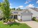Charming single-story home boasts well-manicured lawn and inviting front porch at 215 Windsor Park Dr, Woodstock, GA 30188