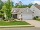 Beautiful one-story home with a two-car garage, meticulously maintained landscaping, and a classic facade at 215 Windsor Park Dr, Woodstock, GA 30188