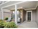 Cozy front porch features comfortable seating, decorative columns, and a welcoming entrance to the home at 215 Windsor Park Dr, Woodstock, GA 30188