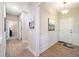 Hallway with hardwood floors leads to bedroom and bathroom past decorative wall art at 215 Windsor Park Dr, Woodstock, GA 30188