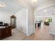 Hallway view looking into office space and kitchen with breakfast bar and living area at 215 Windsor Park Dr, Woodstock, GA 30188