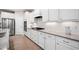 Modern kitchen featuring stainless appliances, granite countertops, and white cabinetry at 215 Windsor Park Dr, Woodstock, GA 30188