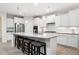 Bright and spacious kitchen features a large island, stainless steel appliances, and white cabinetry at 215 Windsor Park Dr, Woodstock, GA 30188