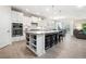 Gourmet kitchen featuring granite countertops, stainless steel appliances, and an island with seating at 215 Windsor Park Dr, Woodstock, GA 30188