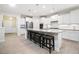 Bright and spacious kitchen features a large island, stainless steel appliances, and white cabinetry at 215 Windsor Park Dr, Woodstock, GA 30188