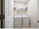 Convenient laundry room with side by side washer and dryer and wire shelving at 215 Windsor Park Dr, Woodstock, GA 30188