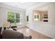 Cozy living room features natural light, crown molding, and wood-look floors at 215 Windsor Park Dr, Woodstock, GA 30188