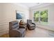 Inviting living room with two armchairs, natural light, and wood-look floors at 215 Windsor Park Dr, Woodstock, GA 30188
