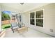 Enclosed porch with outdoor seating, views of the backyard, and a relaxing ambiance at 215 Windsor Park Dr, Woodstock, GA 30188