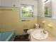 Bathroom with yellow and blue features, includes a window providing plenty of natural light at 3179 Dogwood Dr, Atlanta, GA 30344