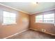 Empty bedroom featuring dual windows, neutral paint, and carpet flooring at 3179 Dogwood Dr, Atlanta, GA 30344