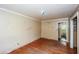 Bedroom featuring hardwood floors, a closet, and a sun-filled window at 3179 Dogwood Dr, Atlanta, GA 30344