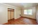 Bedroom featuring hardwood floors, a closet, and a sun-filled window at 3179 Dogwood Dr, Atlanta, GA 30344