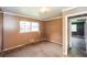 Empty bedroom featuring a large window, neutral paint, and carpet flooring at 3179 Dogwood Dr, Atlanta, GA 30344