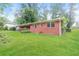View of the side of the home with brick facade, windows and a well-maintained lawn at 3179 Dogwood Dr, Atlanta, GA 30344