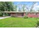 Charming single-story brick home featuring a carport and lush green lawn at 3179 Dogwood Dr, Atlanta, GA 30344