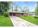 Charming single-story brick home with a well-manicured lawn, and a large driveway at 3179 Dogwood Dr, Atlanta, GA 30344