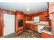 Retro kitchen featuring wood cabinets, appliances, and a side door at 3179 Dogwood Dr, Atlanta, GA 30344