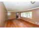 View of empty living room with hardwood floors, painted walls, and a bright window at 3179 Dogwood Dr, Atlanta, GA 30344