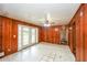 View of empty living room with white tile floors, wood paneling, and French doors at 3179 Dogwood Dr, Atlanta, GA 30344
