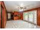 View of empty living room and kitchenette with white tile floors and French doors at 3179 Dogwood Dr, Atlanta, GA 30344