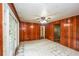 View of empty living room with white tile floors, wood paneling, and French doors at 3179 Dogwood Dr, Atlanta, GA 30344