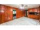View of empty living room with white tile floors, wood paneling, and a ceiling fan at 3179 Dogwood Dr, Atlanta, GA 30344