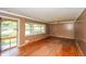 Bright living room featuring hardwood floors, large windows and a door to a grassy front yard at 3179 Dogwood Dr, Atlanta, GA 30344
