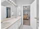 View from bathroom towards the bedroom with double sinks and a large mirror at 3358 North Ct, Ellenwood, GA 30294