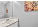 Clean half bathroom features a sink with vanity, decor, and neutral wall color at 3358 North Ct, Ellenwood, GA 30294