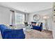 Bright living room featuring a cozy blue sofa set and large windows with sheer curtains at 3358 North Ct, Ellenwood, GA 30294